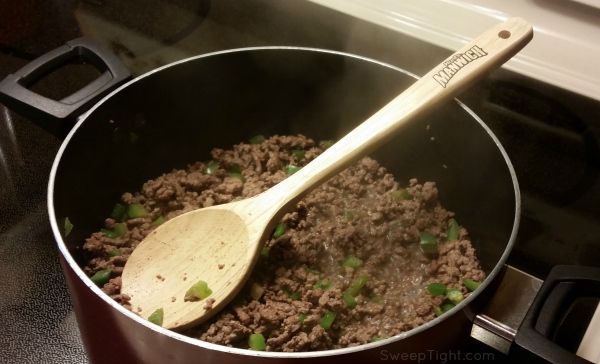 Ground beef and peppers in a pot. 